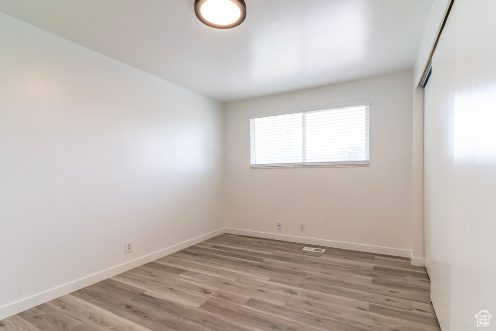 Spare room with light wood-style flooring and baseboards