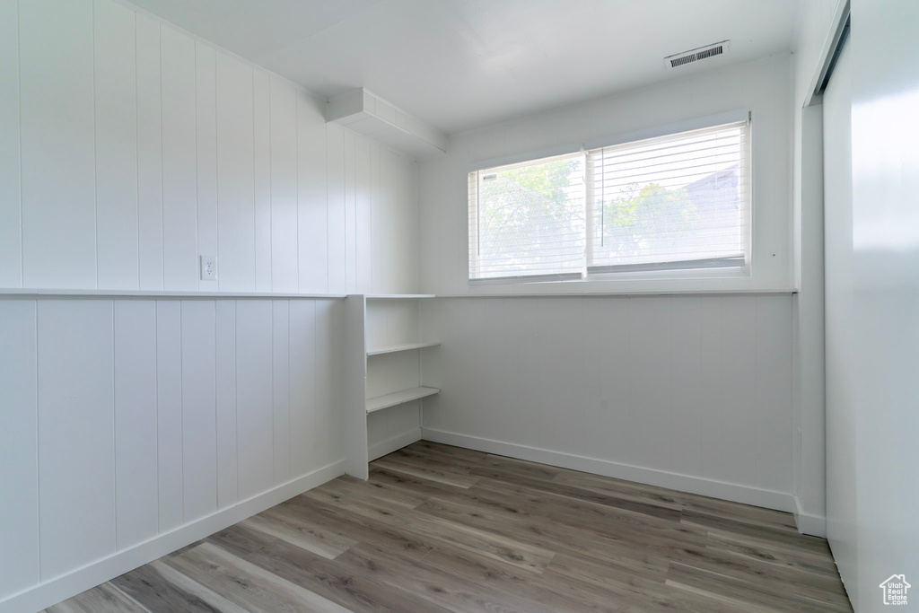 Spare room with wood finished floors and baseboards