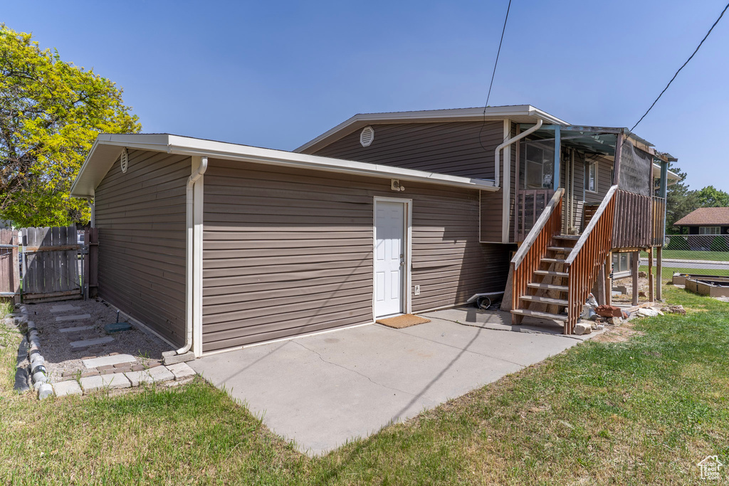 Rear view of house with a patio and stairs