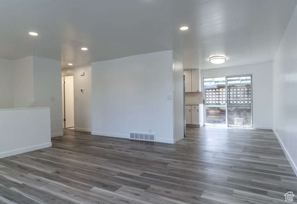 Unfurnished room with recessed lighting, wood finished floors, and baseboards