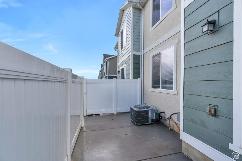 View of patio / terrace with central air condition unit and fence