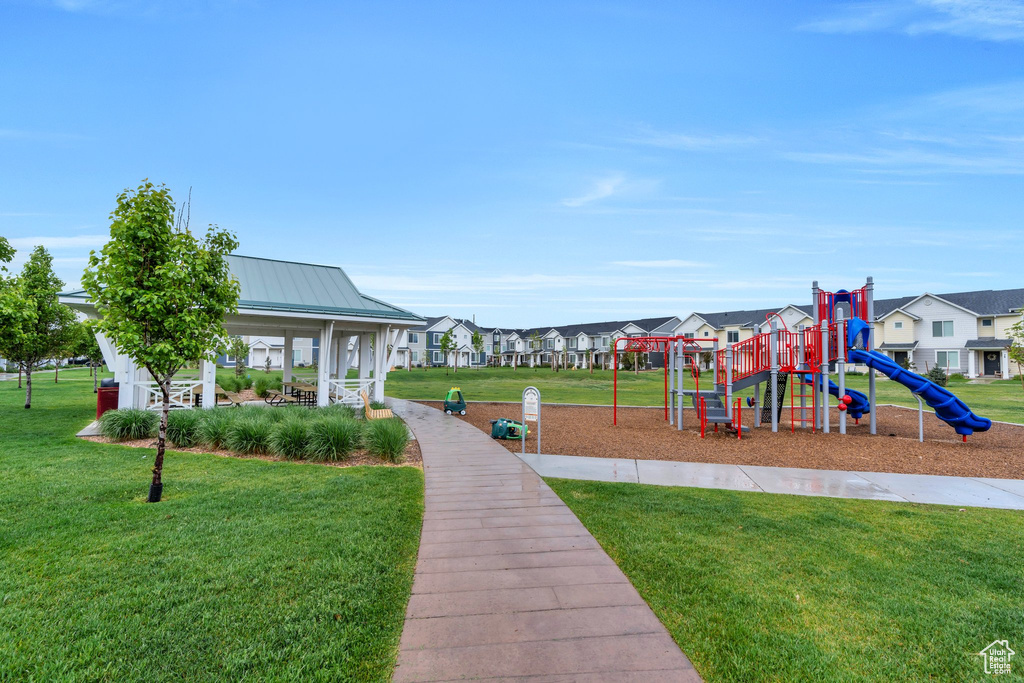 Community jungle gym featuring a residential view, a yard, and a porch