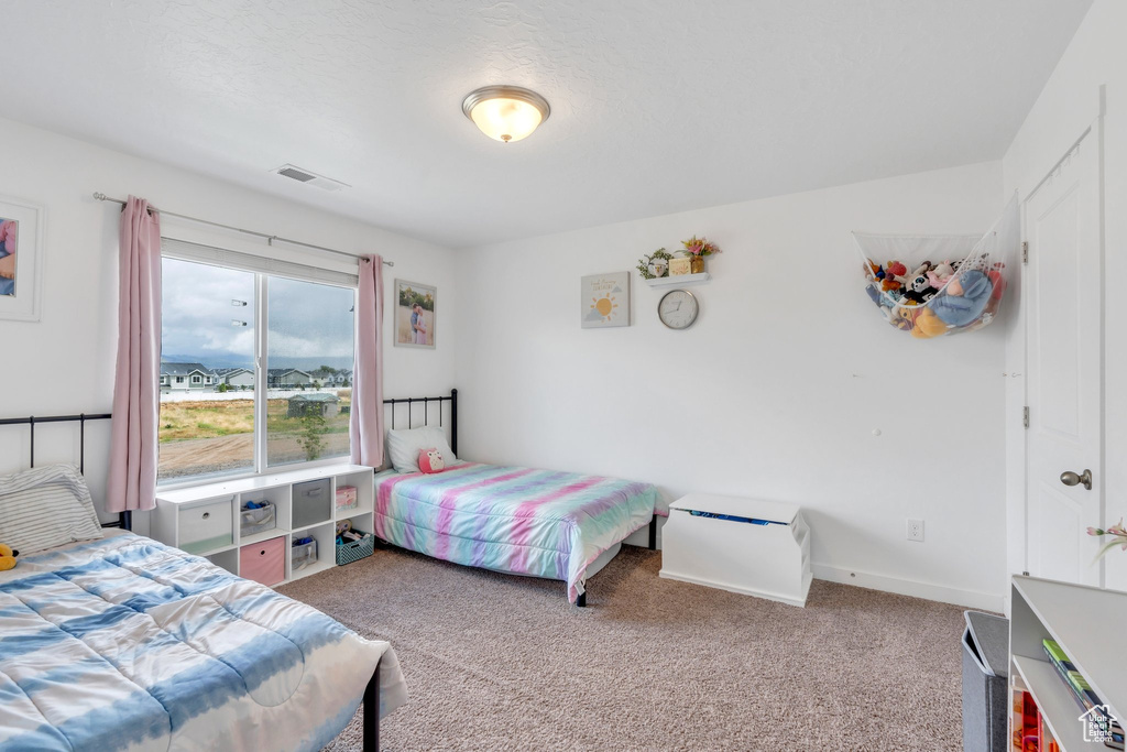 Carpeted bedroom with baseboards