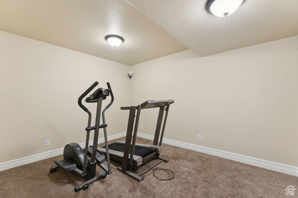 Workout area featuring carpet floors and baseboards