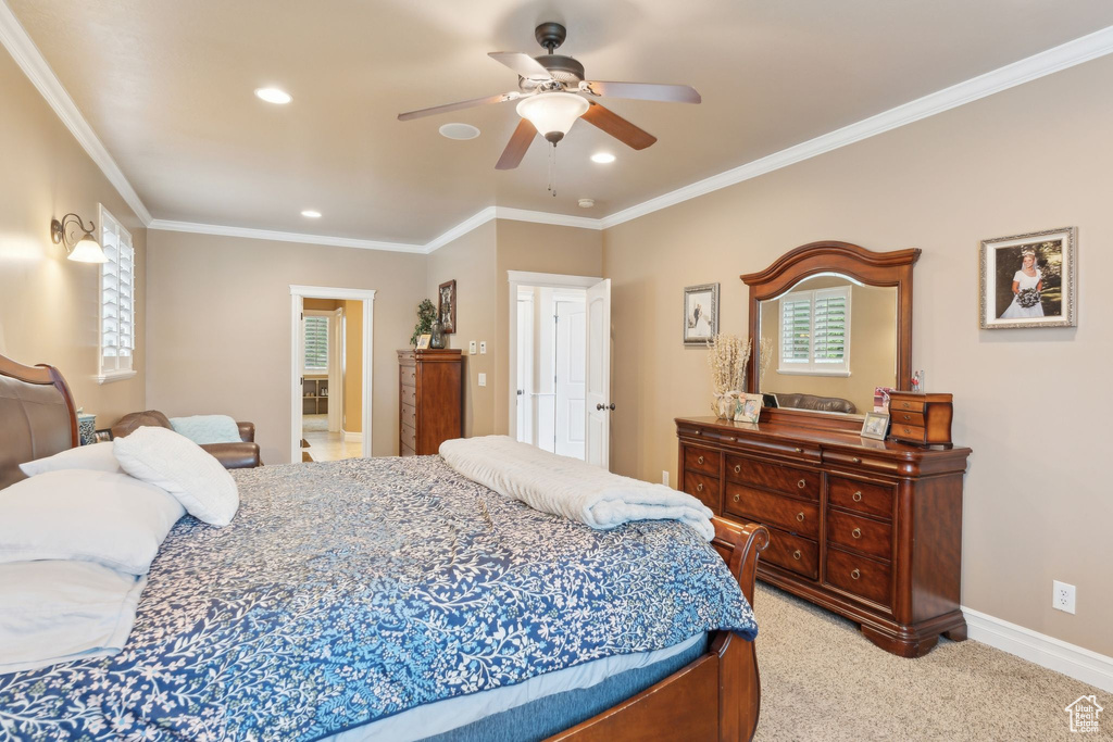 Bedroom featuring multiple windows, ornamental molding, recessed lighting, light carpet, and baseboards