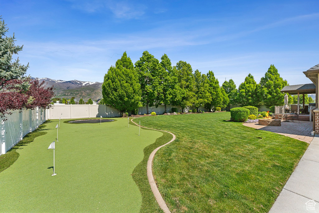View of yard with a putting area, a gazebo, and a mountain view