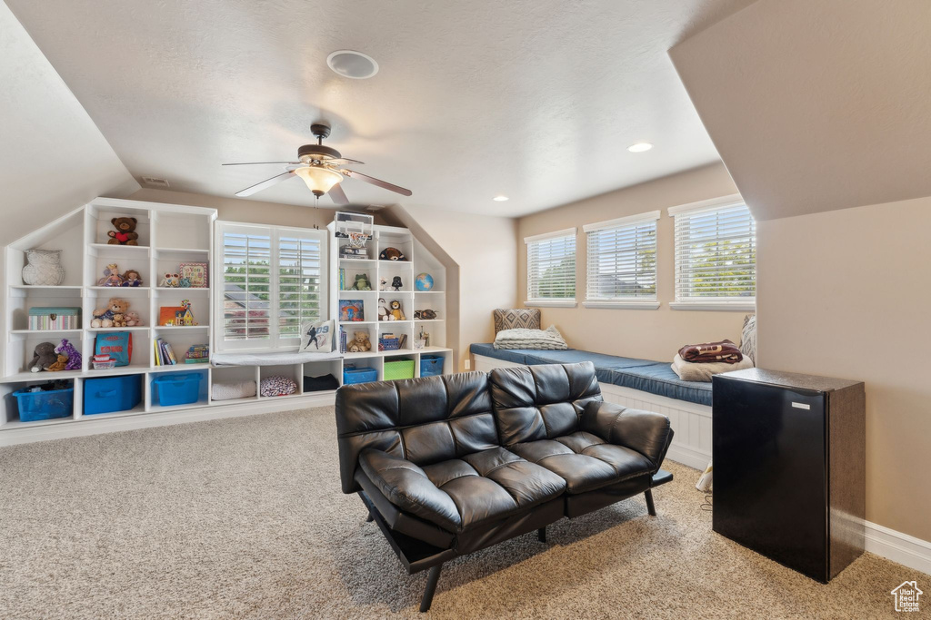 Recreation room featuring light carpet, a ceiling fan, vaulted ceiling, and recessed lighting