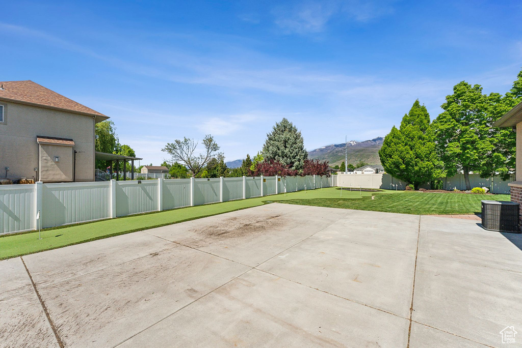 View of patio featuring a mountain view and cooling unit