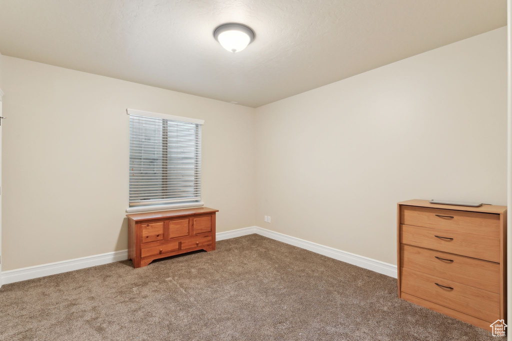 Unfurnished bedroom featuring carpet floors and baseboards
