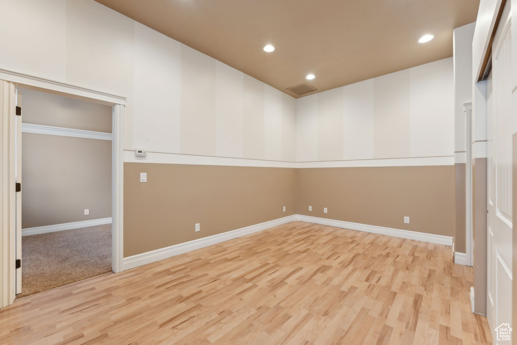 Spare room with light wood-style floors, recessed lighting, and baseboards