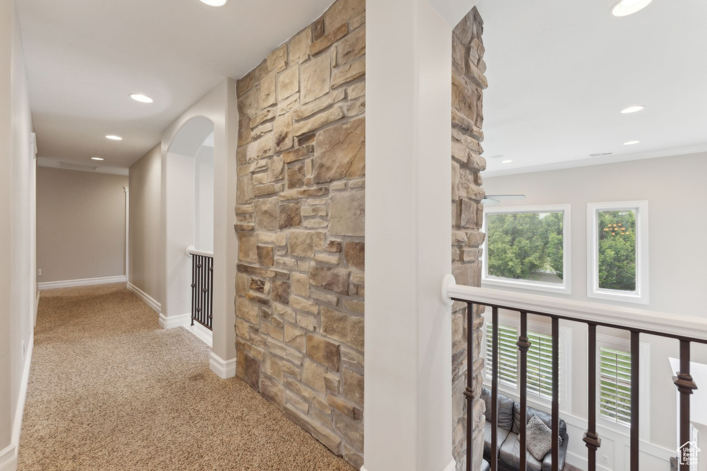 Corridor with carpet flooring, recessed lighting, plenty of natural light, arched walkways, and an upstairs landing