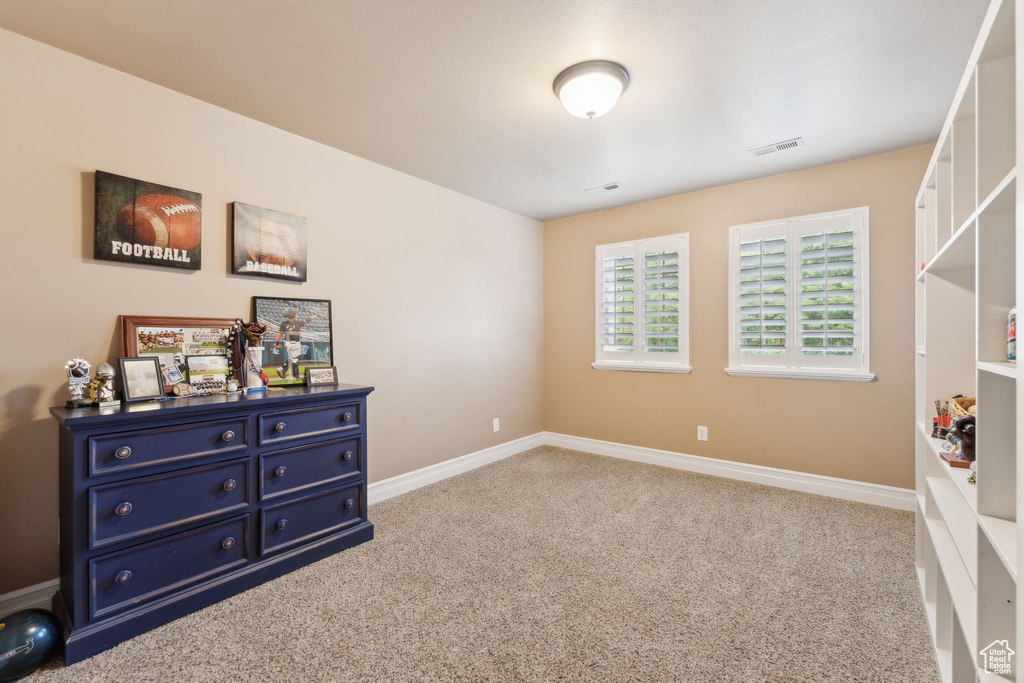 Bedroom featuring carpet flooring and baseboards