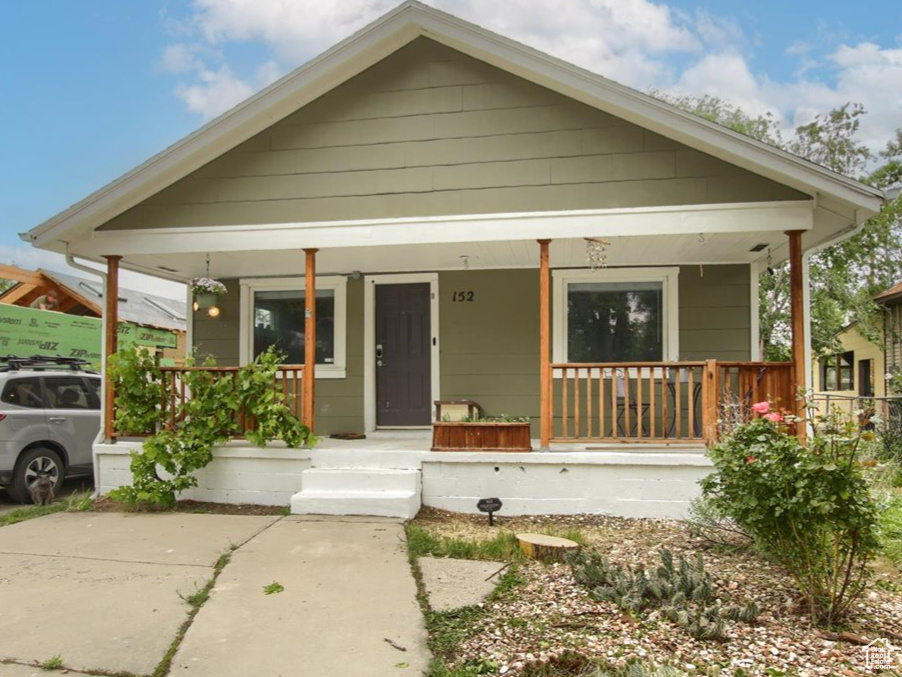 Bungalow-style home featuring a porch and fence