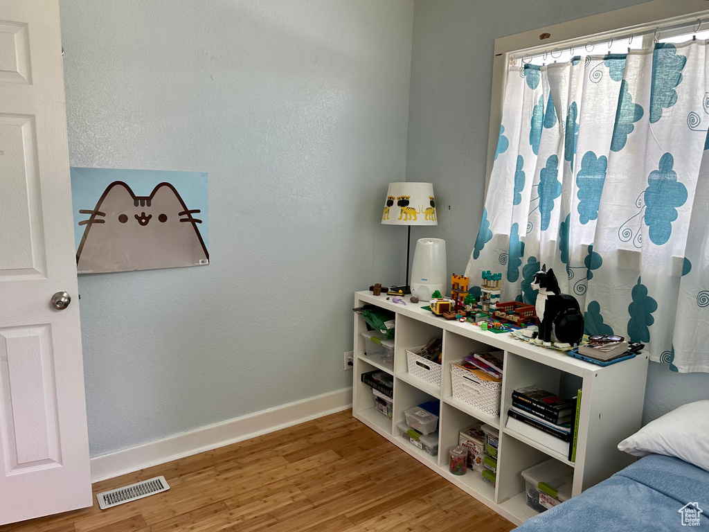 Bedroom with baseboards and wood finished floors