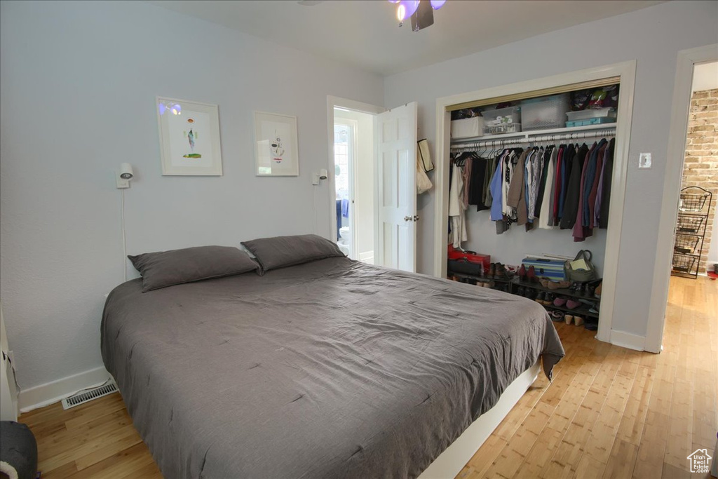 Bedroom featuring wood finished floors, a closet, and baseboards