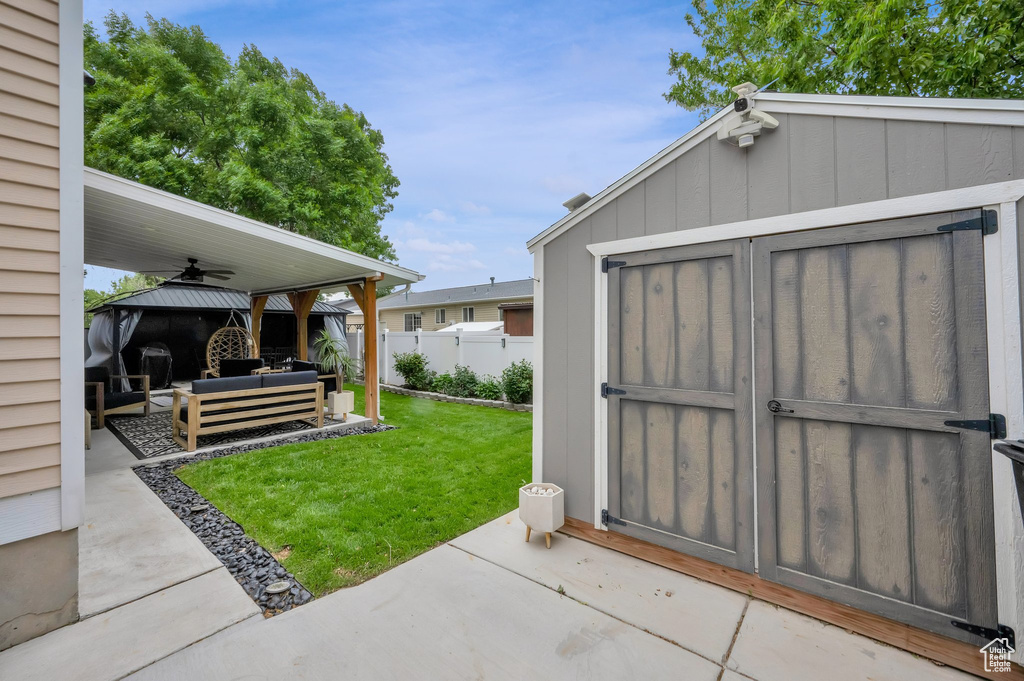 View of yard featuring an outdoor living space, a gazebo, a patio area, and a shed