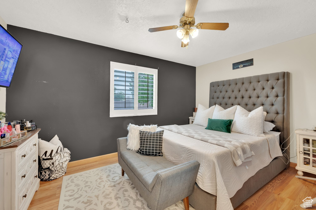 Bedroom with light wood finished floors and ceiling fan
