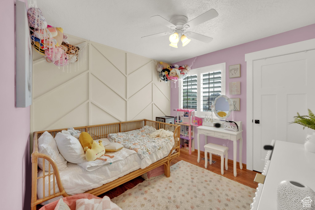 Bedroom with wood finished floors and ceiling fan