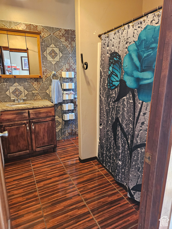 Bathroom featuring vanity, wood finished floors, and a shower with shower curtain
