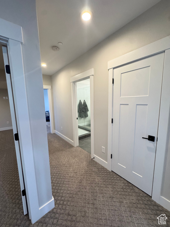 Corridor featuring carpet floors, baseboards, and recessed lighting