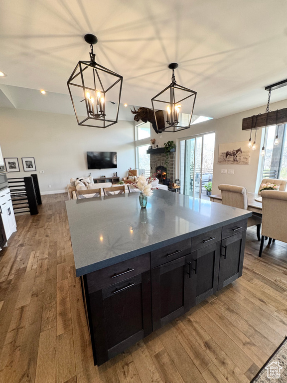 Kitchen with open floor plan, hardwood / wood-style floors, a chandelier, plenty of natural light, and recessed lighting