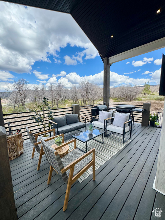 Wooden deck featuring an outdoor hangout area