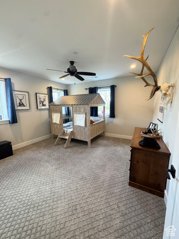 Bedroom with carpet, baseboards, and ceiling fan
