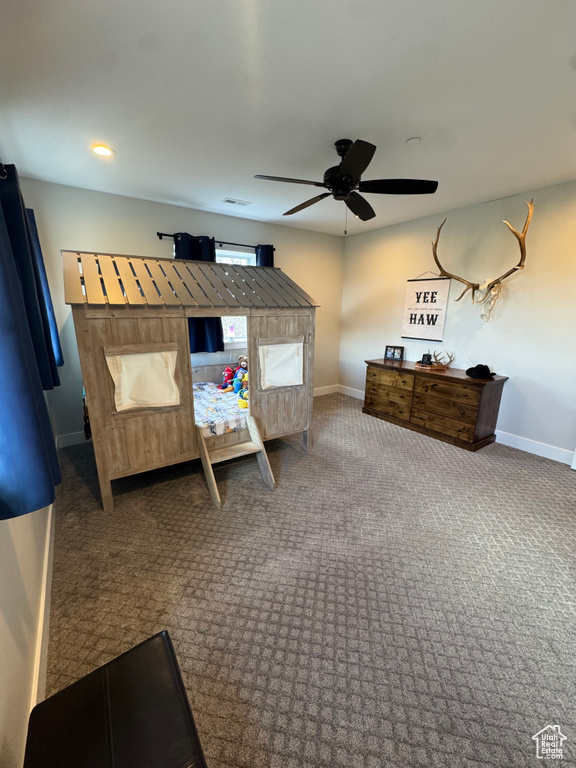 Carpeted bedroom featuring baseboards and a ceiling fan