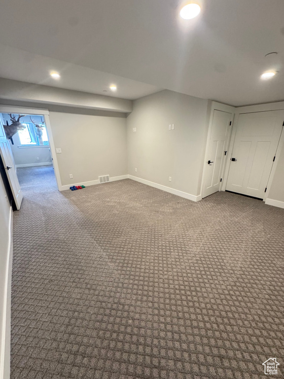 Basement featuring baseboards, recessed lighting, and carpet flooring