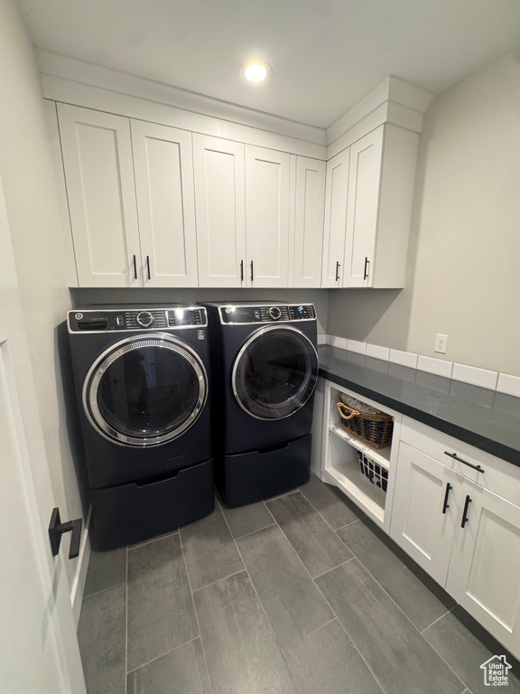 Laundry area featuring washing machine and clothes dryer, cabinet space, and recessed lighting