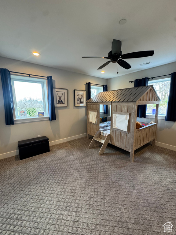 Carpeted bedroom with multiple windows, baseboards, recessed lighting, and a ceiling fan