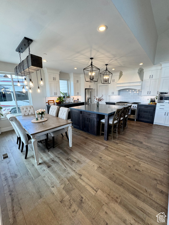Dining space featuring a chandelier, wood finished floors, and recessed lighting