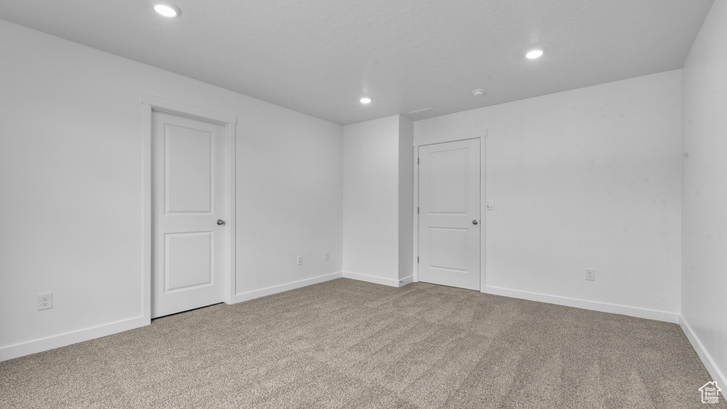 Empty room featuring recessed lighting, carpet flooring, and baseboards