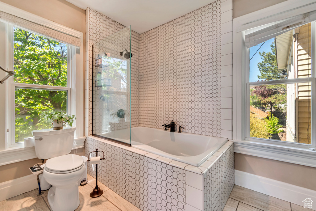Full bath with toilet and baseboards