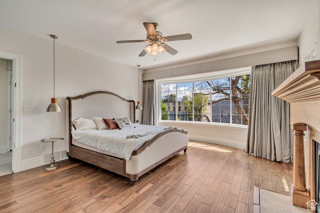 Bedroom featuring wood finished floors, baseboards, and a ceiling fan