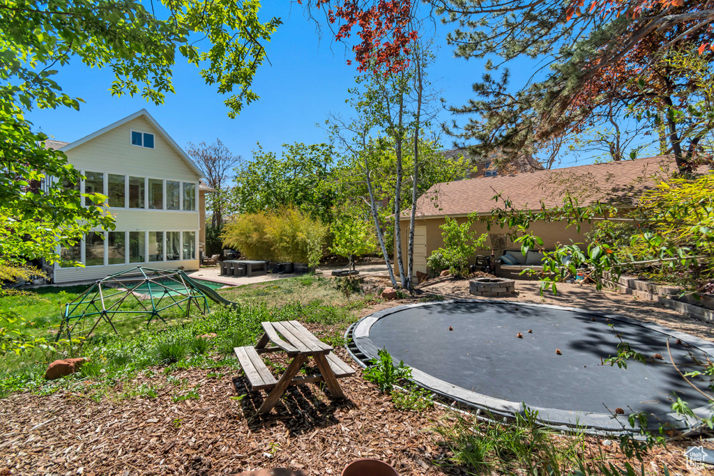 View of yard featuring a fire pit and a patio area