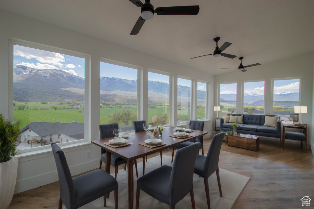 Sunroom featuring a mountain view and vaulted ceiling
