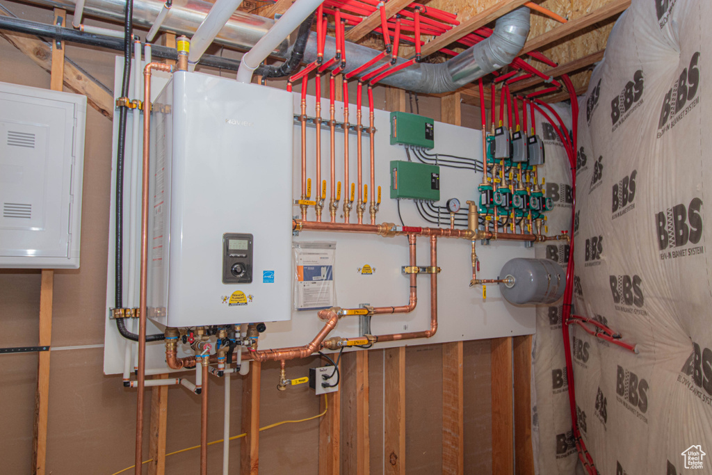 Utility room with water heater and electric panel