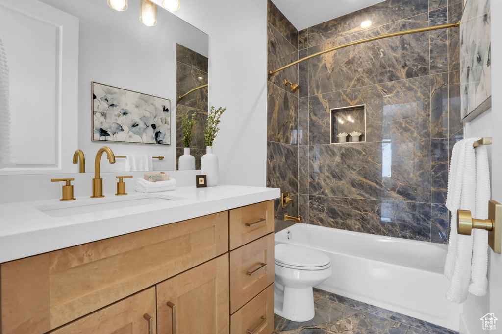 Full bathroom featuring toilet, bathtub / shower combination, and vanity