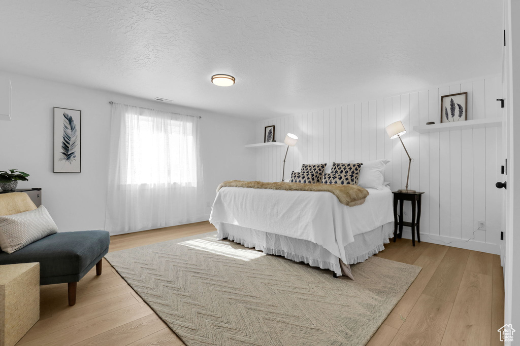 Bedroom featuring light wood-style floors and a textured ceiling