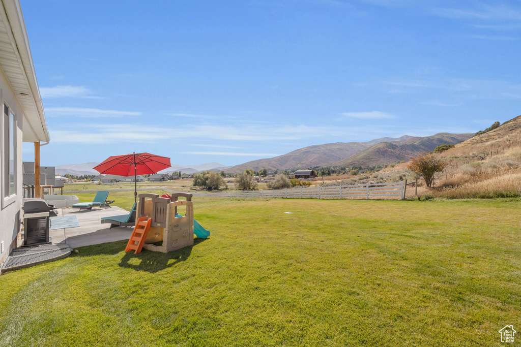 View of yard featuring a mountain view and a patio