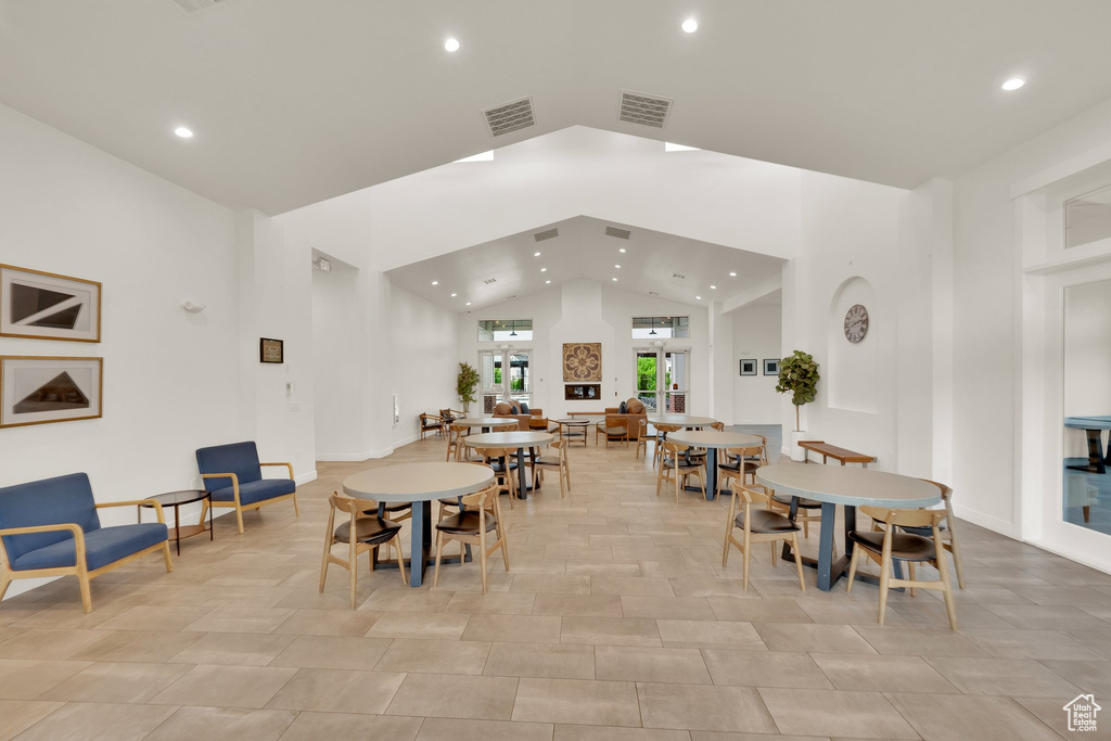 Dining space with recessed lighting and high vaulted ceiling