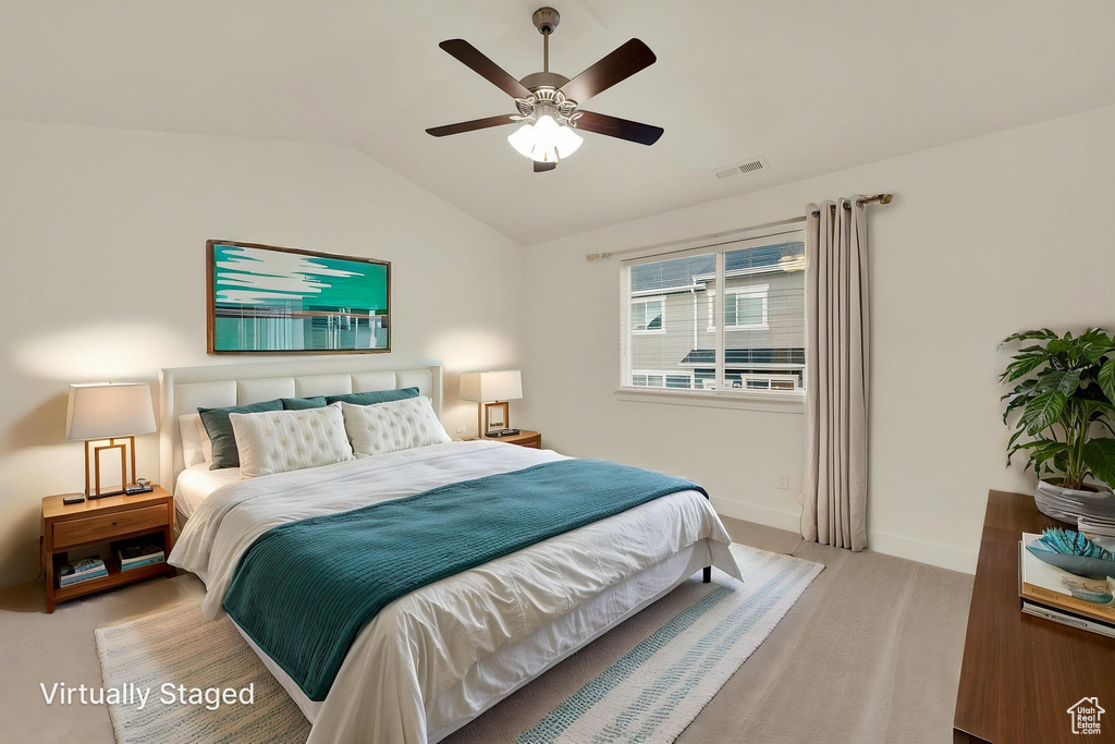 Bedroom with lofted ceiling, carpet, baseboards, and ceiling fan