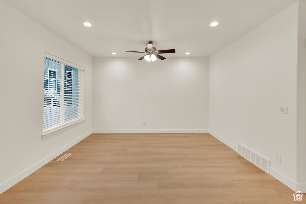 Spare room featuring recessed lighting, a ceiling fan, baseboards, and light wood-style floors