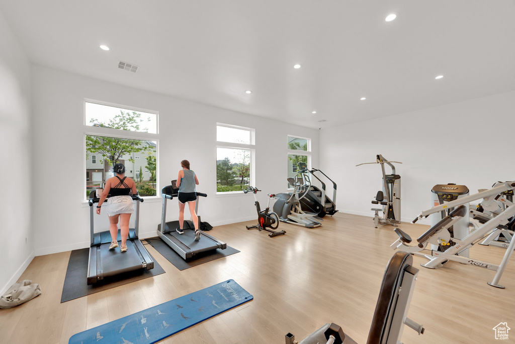Gym with wood finished floors, recessed lighting, and baseboards