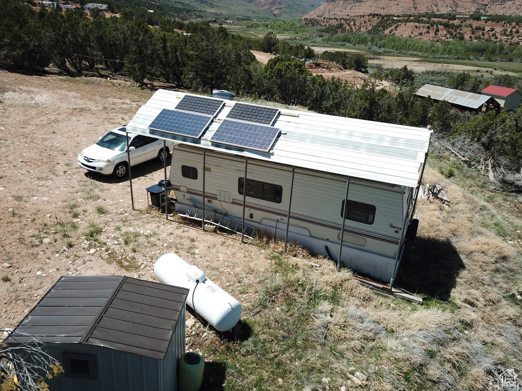 View of side of home featuring solar panels and a mountain view