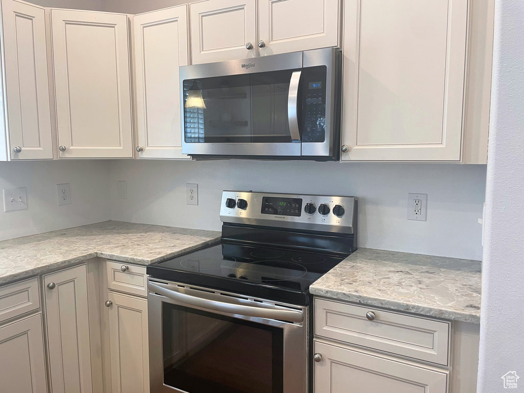 Kitchen with stainless steel appliances and white cabinets