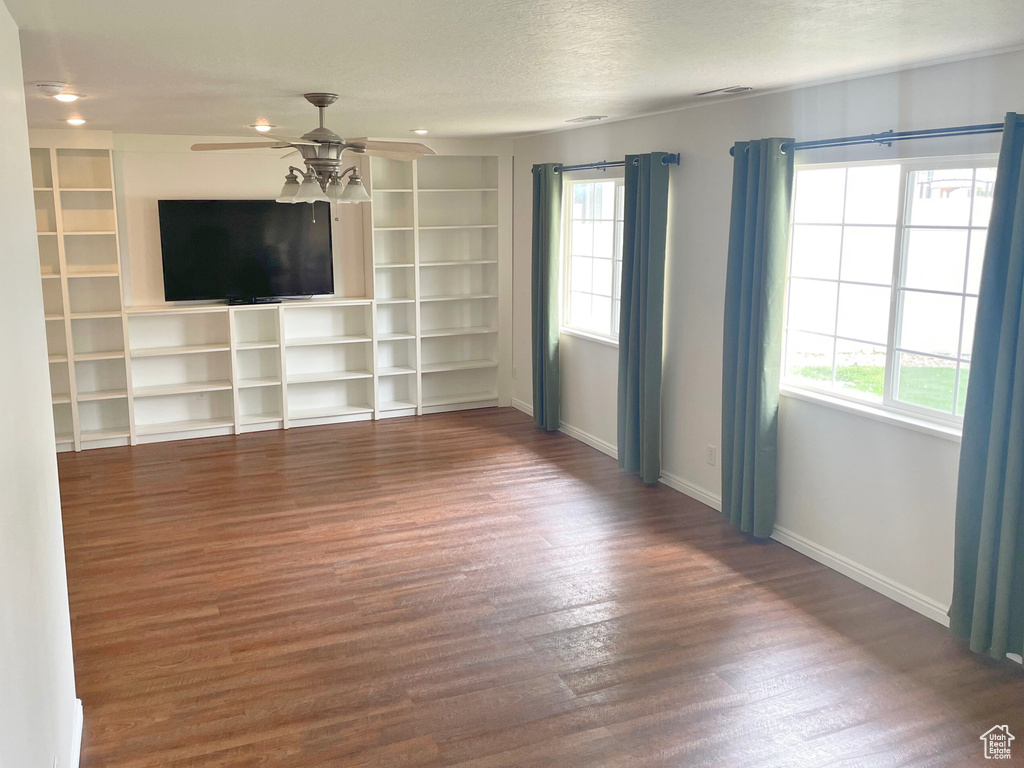 Unfurnished living room featuring a ceiling fan, plenty of natural light, wood finished floors, baseboards, and recessed lighting