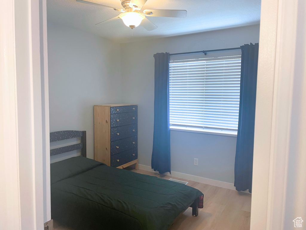 Bedroom featuring wood finished floors and a ceiling fan