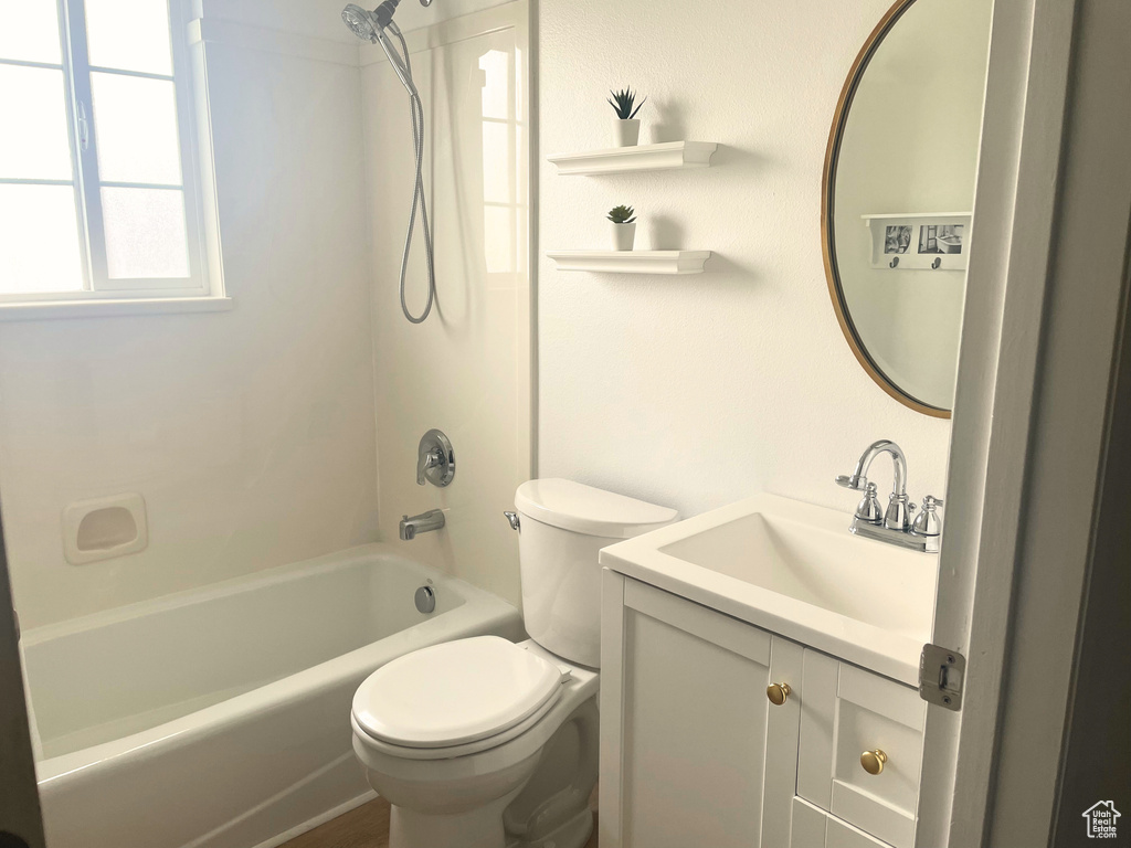 Bathroom with toilet, vanity, and tub / shower combination